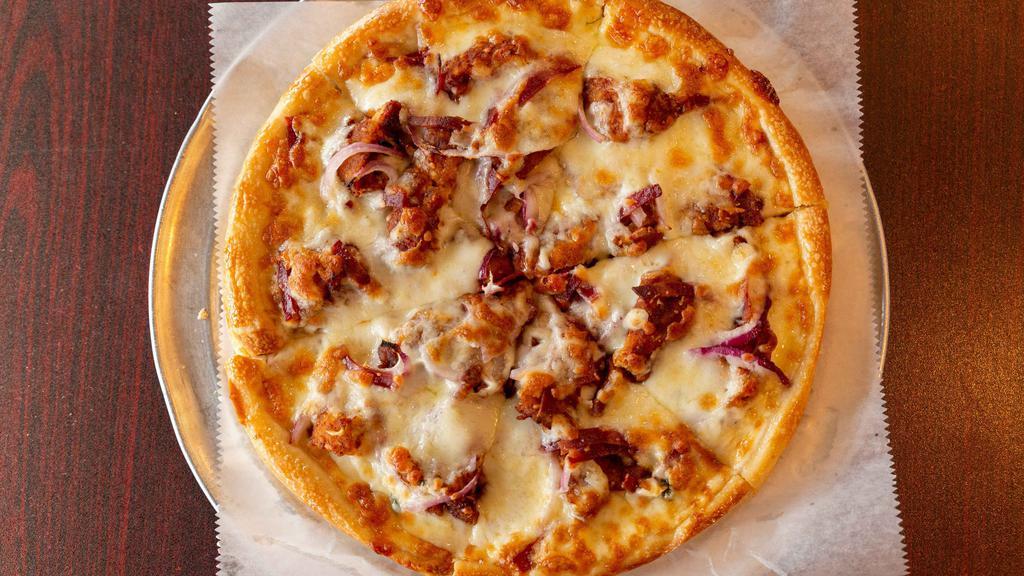 Barbecue Chicken Pizza · Crispy chicken tossed in BBQ sauce with cheese, onions and bacon.