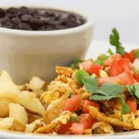 Migas Plate · A staple in Mexican cuisine.  Scrambled eggs and corn chips simmered in our spicy salsa ranc...