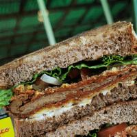 Vegan Steak Sandwich · Homemade seitan fried milanesa, lettuce, tomatoes, onion, pickles, mustard & vegan mayo. Our...