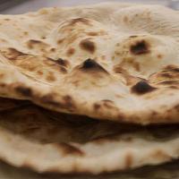 Naan · Traditional, hand made naan, fresh from the tandoor oven.