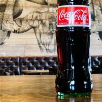 Mexican Coke · Classic Coca Cola made with real cane sugar! Bottle opener required to open. 12 fl. oz