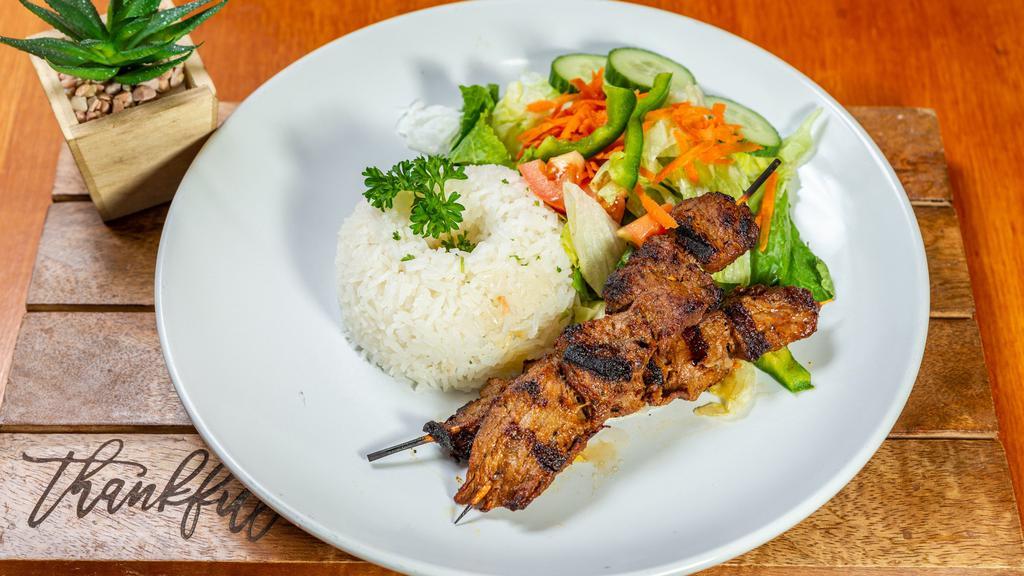 Beef Anticuchos · Marinated grilled meat on skewers. Served with rice.