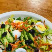 Rotisserie Chicken Salad · Romaine lettuce tossed with tomatoes, red onions, cucumbers and hard boiled eggs topped with...