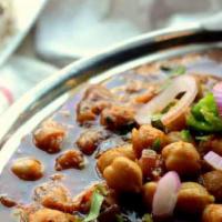 Channa Masala · Garbanzo beans cooked with Indian spices and tomatoes and onion sauce.