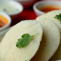 Idli · Steamed rice and lentil patties served with savory chutneys and side of sambar