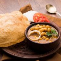 Chole Bhatura · Puffed bread made from all purpose flour served with Chickpea curry.