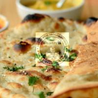 Garlic Naan · Bread made in tandoor oven is topped with minced garlic