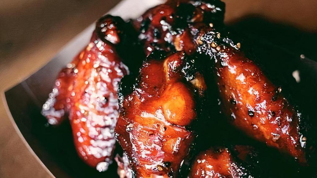 Smoked Chicken Wings · 10 of our smoked and dry rubbed wings covered in our signature glaze. Mixed drumettes and flats, sorry no substitutions.