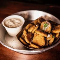Fried Pickles · Crispy Dill Pickles topped with Cilantro and Cotija Cheese served with our House Made Ranch.