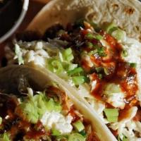 2 Bbq Style Flour Tacos With One Side · 2 Flour Tortillas Filled with Your Choice of Meat, Topped with Creamy Slaw, Green Onions, an...