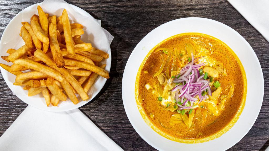 Khao Soi · French Fries, sliced red onion, green onion in homemade coconut curry.