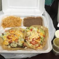 Puffy Taco Plate · Two puffy tacos. served W/ rice beans 
your choice beef or chicken