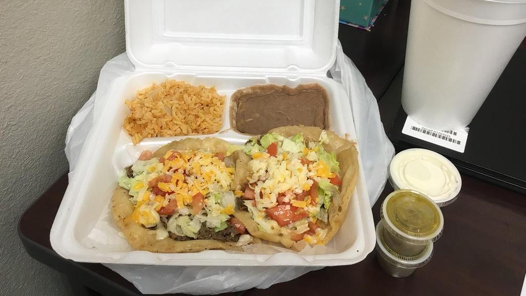 Puffy Taco Plate · Two puffy tacos. served W/ rice beans 
your choice beef or chicken