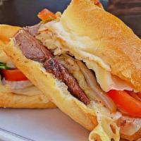 New York Steak Sandwich · Fire Grilled NY Steak, Sliced with Grilled Onions and Garlic, Arugula, Tomato, and Melted Fo...