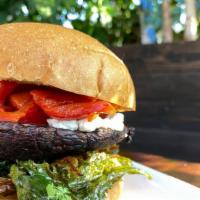 Portobello Burger · Grilled Portobello mushroom with roasted kale, roasted bell peppers, goat cheese, all on a b...