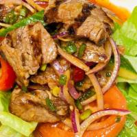 Grilled Beef Salad · Tossed with cucumber, garlic, tomato, red onion, celery, chili paste, lime juice and Thai co...