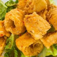 Fried Calamari Salad · Lightly breaded fried calamari with house sweet & sour dressing on top of mixed vegetable. (...