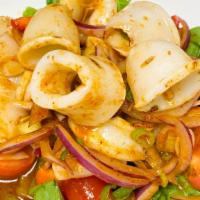 Spicy Squid Salad · Steam squid rings tossed with lemongrass, garlic, red onion, tomato, cucumber, lime juice an...