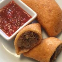Empanada Colombiana · Flavorful corn flour fried pastry filled with beef and potatoes.