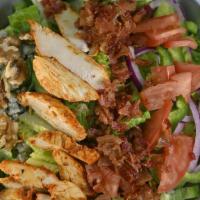 Chicken Chop Salad · Bacon, walnuts, medley of greens, gorgonzola cheese, peppers, onions, tomatoes & cucumber to...