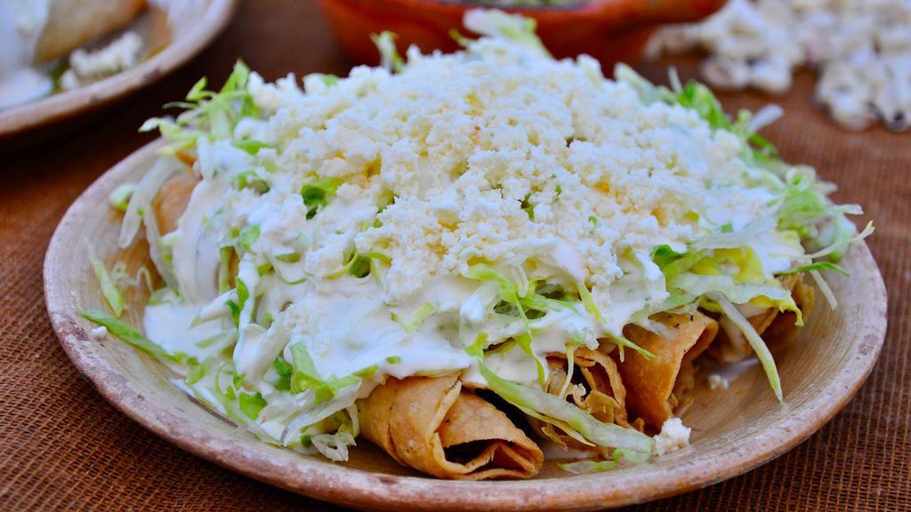 Flautas (4) · 4 corn or flour tortillas filled with your choice chicken or steak, deep-fried then topped with sour cream and guacamole.