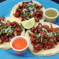 Tacos Al Pastor (Marinated Pork) · Three soft corn tacos with marinated pork. Served with rice, beans, pico de gallo and guacam...