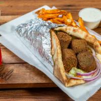 Mediterranean Falafel Over Rice · Five pieces of falafel served with basmati rice, salad and homemade sauces.