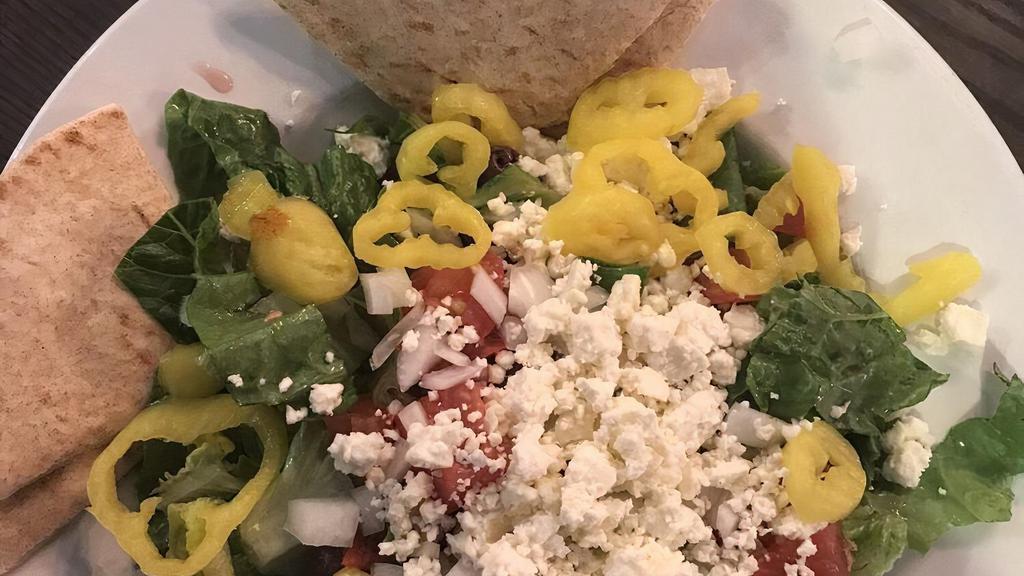 Greek Salad · Vegetarian. Romaine, Kalamata, olives, onions, mild pepper, tomato, feta cheese, and balsamic dressing.