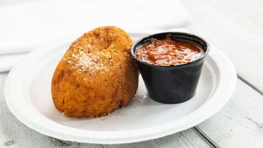 Arancina ( Rice Ball) · A traditional Sicilian treat. Rice ball stuffed with ground beef, sweet peas, and a touch of sauce. Served with a side of meat sauce.