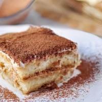 Tiramisu · Layers of espresso drenched sponge cake divided by marscarpone cream,dusted with cocoa powder
