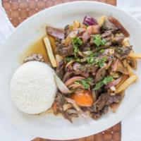 Lomo Saltado · Sautéed beef with onions and tomatoes served on top of fries and side of rice.