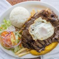 Bistec A Lo Pobre · Thinly sliced steak, fries, rice, plantains, salad and fried egg.
