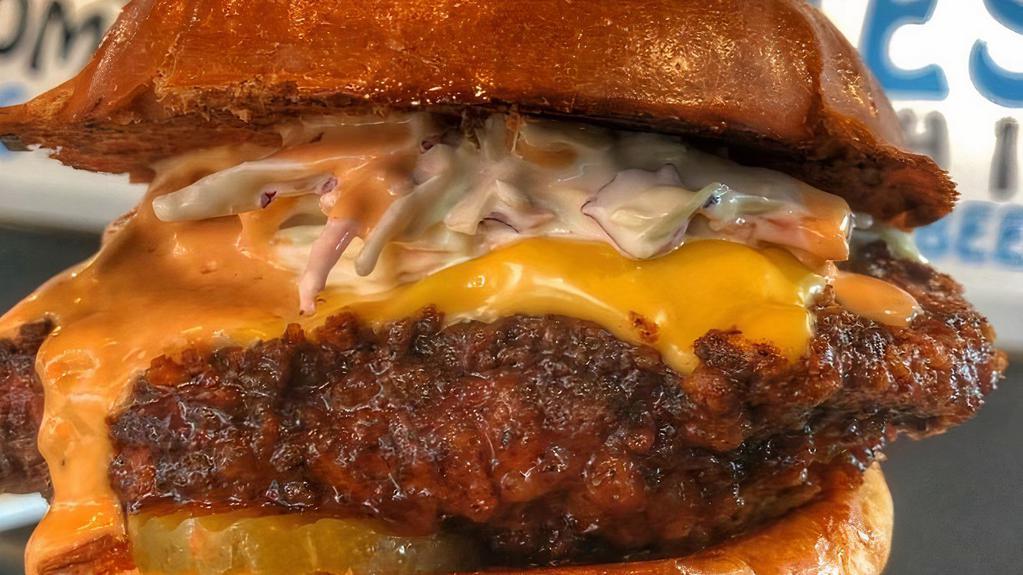 Nash Me Up Chicken · Fresh marinated chicken fried patty dipped in Nashville sauce, topped with American cheese, creamy coleslaw & pickle.