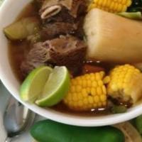 Sopa De Res / Beef Soup · Beef chucks in hearty beef broth with cabbage, corn on the cobb, yuca, carrots and tortillas.