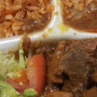 Carne Guisada · Beef gravy, rice, beans, lettuce, tomato & guacamole.