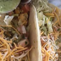 Tilapia Fillet Tacos · Topped with shredded cheese, pico de gallo, and lettuce.