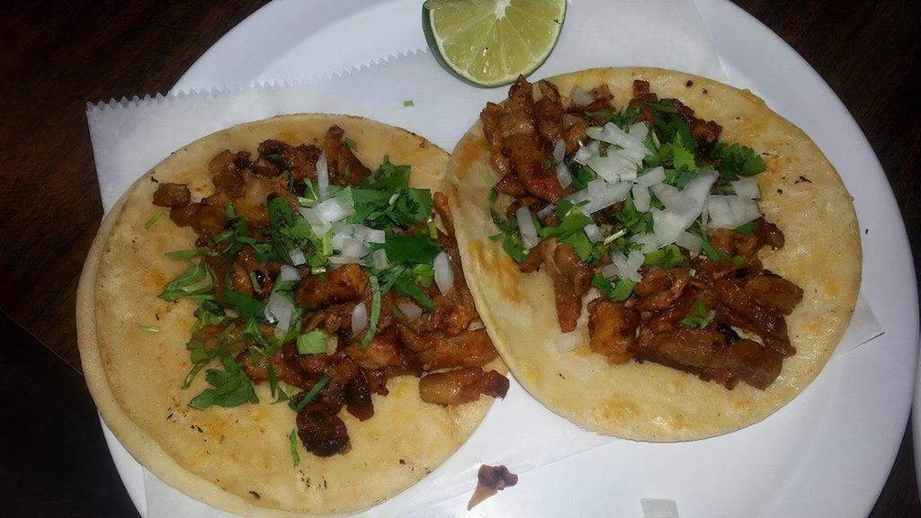 Tacos · Delicious tacos served with choice of meat, cilantro and onions.