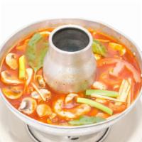 Seafood Hot Pot · Vegan shrimp, vegan fish, mushroom, tomatoes, ginger, and basil in clear broth hot and sour ...