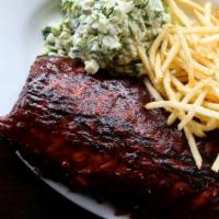 Barbeque Pork Ribs · Slow cooked ribs topped with BBQ sauce, served with French fries and coleslaw.