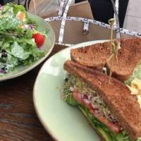 Veggie · Toasted wheat bread, pesto aioli, avocado, tomato, lettuce, and sprouts, and red onions. 
Se...