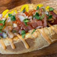 Sonora Dog · 1/4 Pound all beef hot dog wrapped in bacon topped with onions, tomatoes, jalapeños topped w...