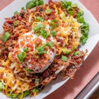 Loaded Baked Potato · Served with Sharp Cheddar, Sour Cream, Butter, Bacon and Green Onions.