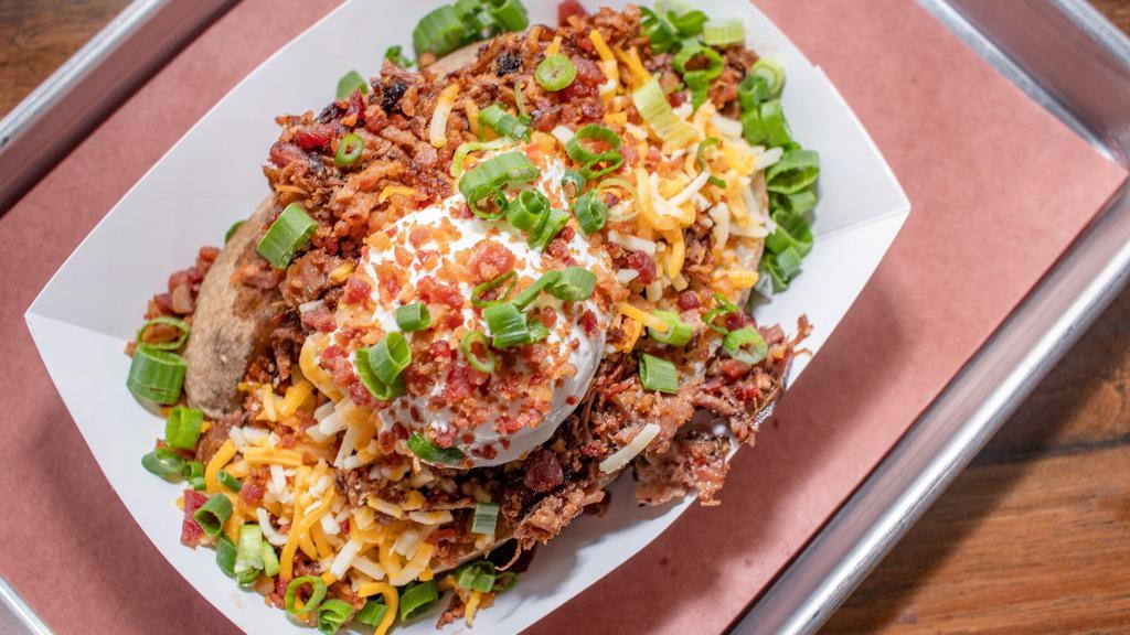 Loaded Baked Potato · Served with Sharp Cheddar, Sour Cream, Butter, Bacon and Green Onions.