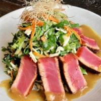 Seared Ahi Tuna Salad · sushi grade tuna, dusted with spicy pepper
seasoning, served over asian salad with
soy onion...