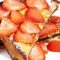 Strawberry French Toast · Sliced challah bread soaked in eggs and milk, then fried and topped with strawberries, serve...