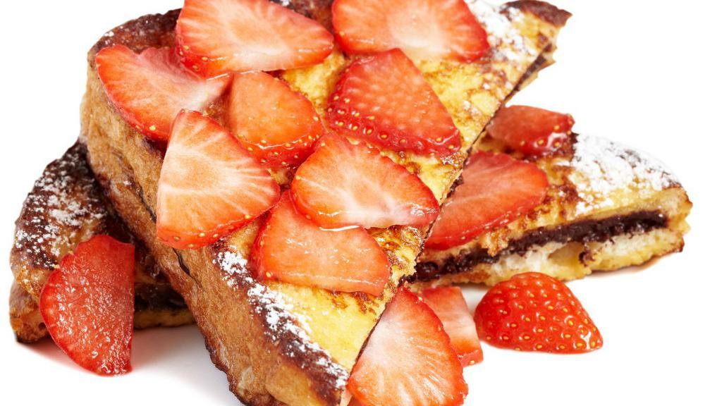 Strawberry French Toast · Sliced challah bread soaked in eggs and milk, then fried and topped with strawberries, served with a side of butter and syrup.
