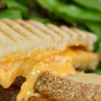 The Grilled Pimiento Cheese · Our signature spicy blend of Dragon's Breath, Adam's Reserve Cheddar, Dubliner & pimiento pe...