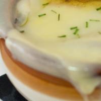French Onion Soup · Topped with baguette and gooey Gruyère.