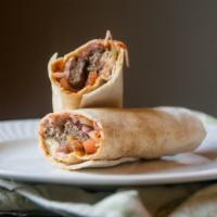 Kofta Kabob · Minced beef with parsley and spices grilled to perfection. Served on pita bread topped with ...