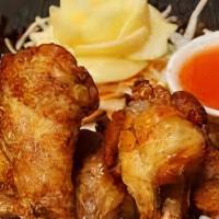 Peak Gai Tod · Whole chicken wings marinated and fried with Thai herbs, with a sweet Thai chili sauce.